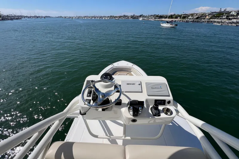 Slide: The Image of 2019 Boston Whaler 380 Outrage helm with Garmin navigation, overlooking calm waters. - 4