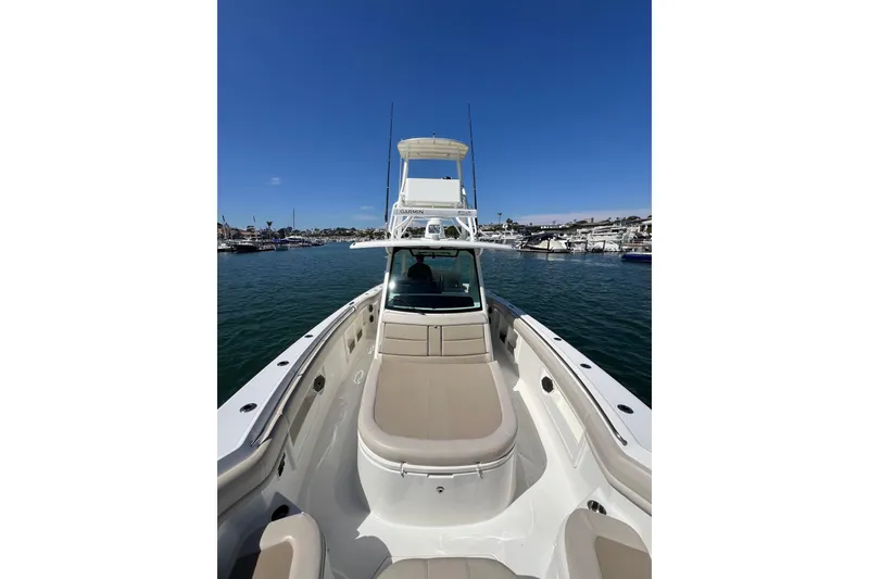 Slide: The Image of 2019 Boston Whaler 380 Outrage boat on calm water under clear blue sky. - 7