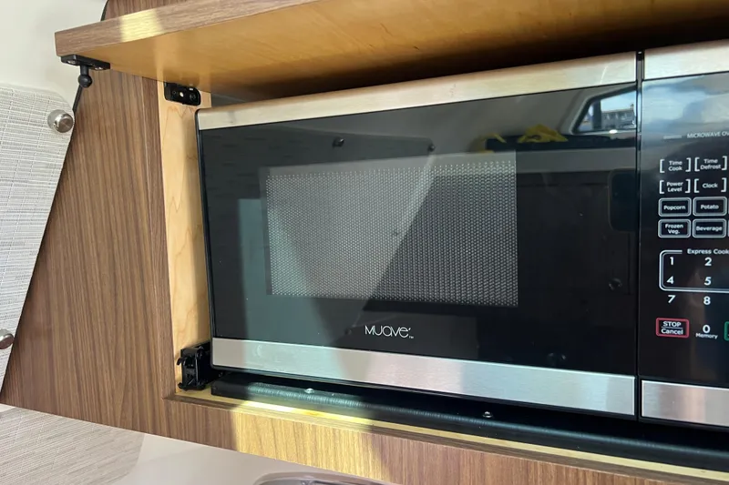 Slide: The Image of Microwave oven inside 2019 Boston Whaler 380 Outrage boat kitchen area. - 8