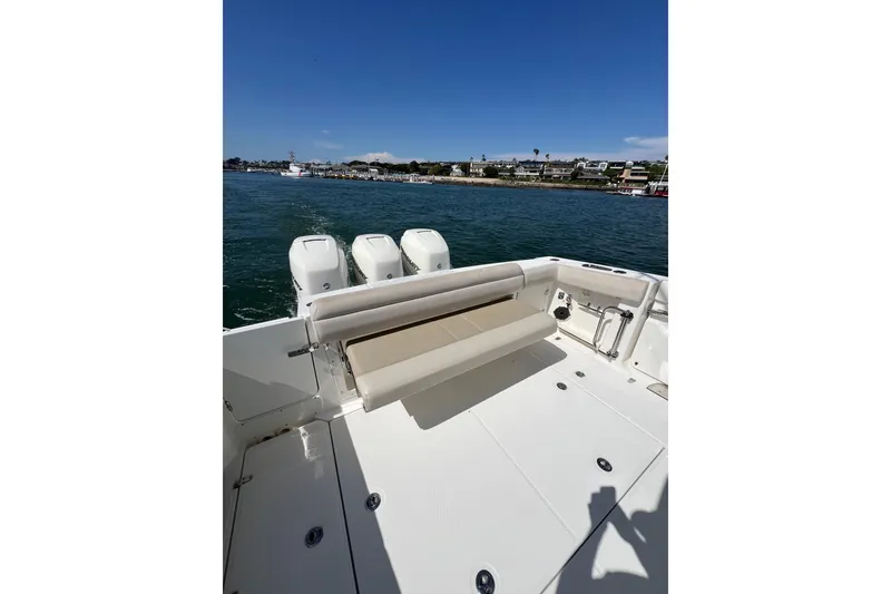 Slide: The Image of 2019 Boston Whaler 380 Outrage boat with triple engines on calm water. - 9