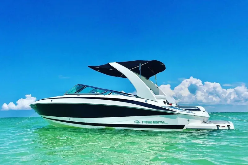The Image of 2012 Regal 2500 Bowrider boat on clear turquoise water under a bright blue sky. - 0