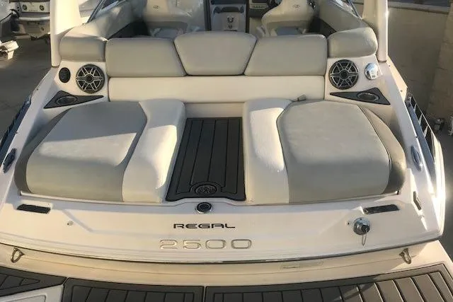 Slide: The Image of 2012 Regal 2500 Bowrider boat with cushioned seating and sleek design. - 13