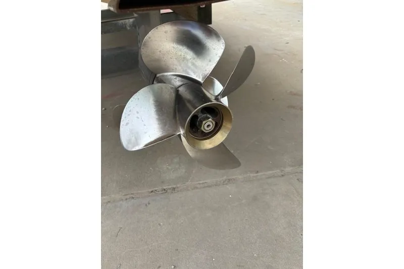 Slide: The Image of Stainless steel propeller of a 2012 Regal 2500 Bowrider boat on concrete surface. - 15