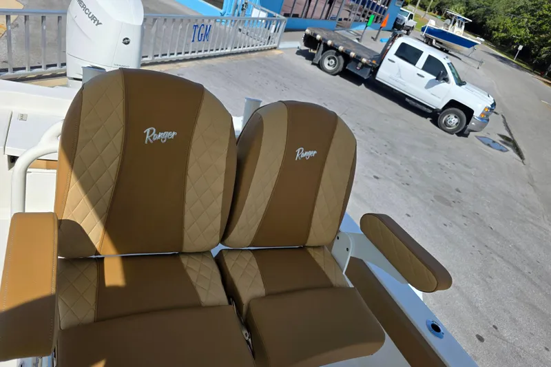 Slide: The Image of 2026 Ranger 2660 Bay boat interior with tan seating and cup holders. - 15