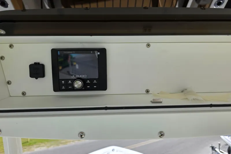 Slide: The Image of Control panel on a 2026 Ranger 2660 Bay boat, featuring switches and a dial. - 23