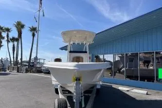 Slide: The Image of 2026 Ranger 2660 Bay boat, rear view, parked outdoors on a sunny day. - 4