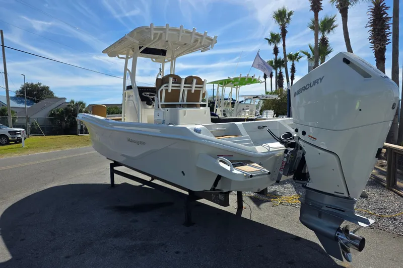 Slide: The Image of 2026 Ranger 2660 Bay boat with Mercury engine, parked outdoors under a clear sky. - 7