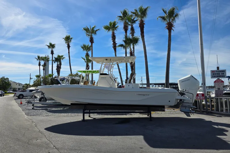 Slide: The Image of 2026 Ranger 2660 Bay boat with Mercury engine, parked outdoors under a clear blue sky. - 9