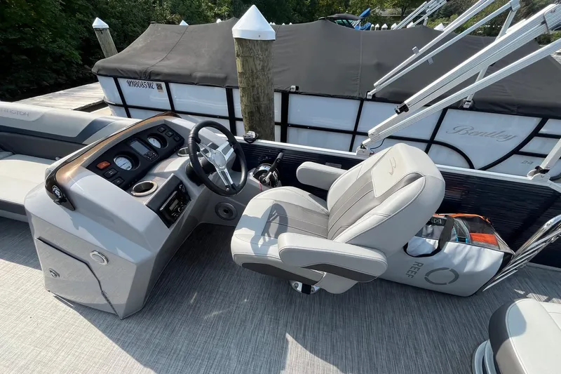 Slide: The Image of 2021 Bennington 21 SSBX boat interior with steering console and captain's chair. - 12