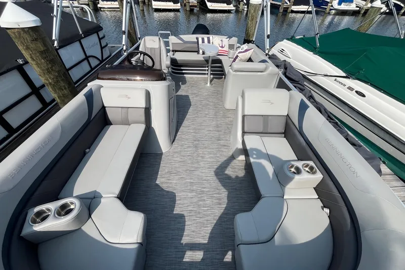 Slide: The Image of 2021 Bennington 21 SSBX pontoon boat interior with plush seating and cup holders. - 20