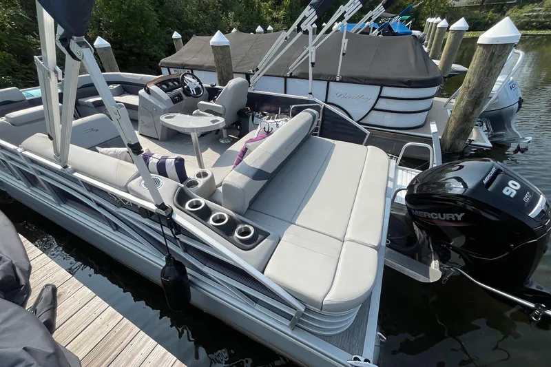 Slide: The Image of 2021 Bennington 21 SSBX pontoon boat docked with Mercury 90 engine. - 5