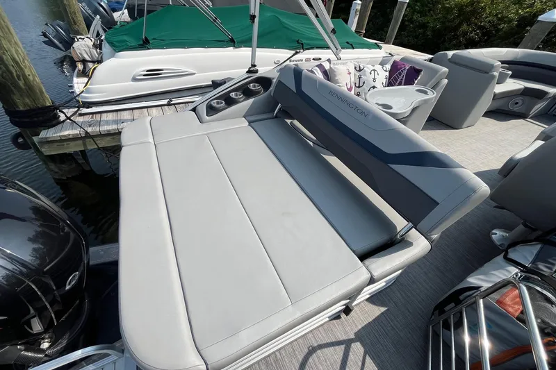 Slide: The Image of 2021 Bennington 21 SSBX pontoon boat with gray seating and cup holders. - 7