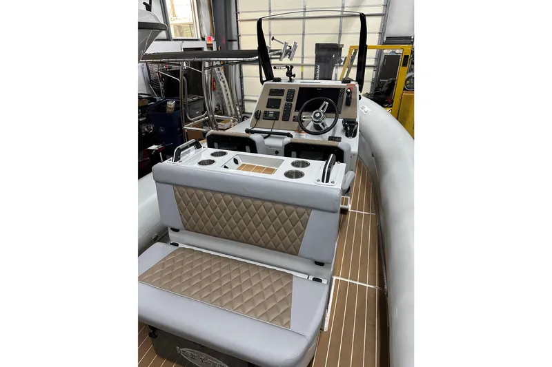 Slide: The Image of Interior of a 2022 Sealegs 7.5M boat with quilted seating and modern dashboard. - 10
