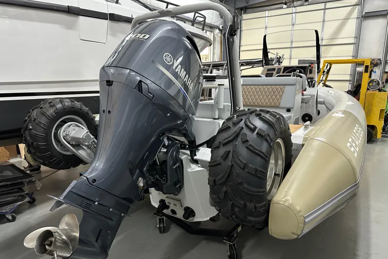 Slide: The Image of 2022 Sealegs 7.5M amphibious boat with Yamaha engine in a garage setting. - 13