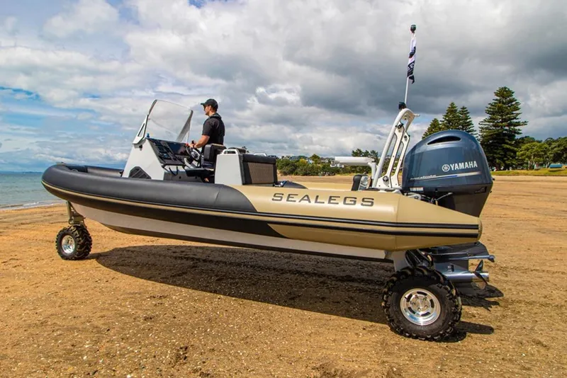Slide: The Image of Control panel of a 2022 Sealegs 7.5M boat with steering wheel and navigation equipment. - 7