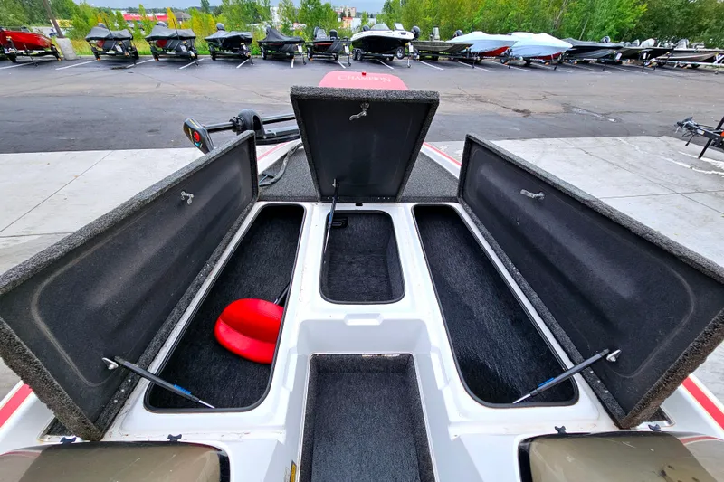 Slide: The Image of 1998 Champion 187 DLX Elite boat storage compartments open, showcasing interior space. - 12