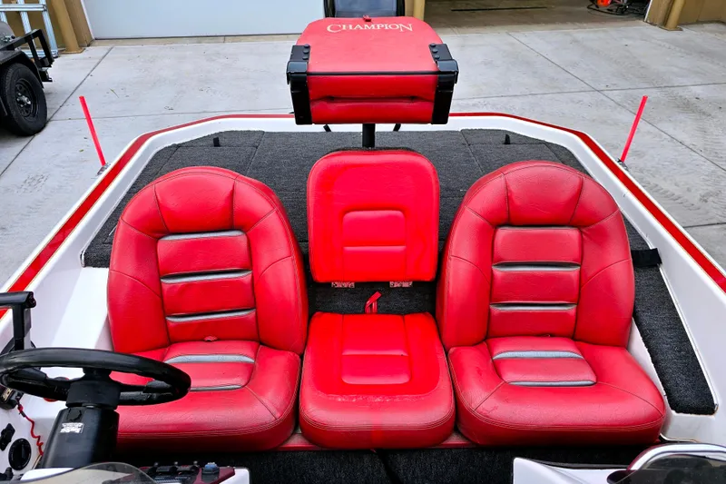 Slide: The Image of 1998 Champion 187 DLX Elite boat with red leather seats and steering wheel. - 18