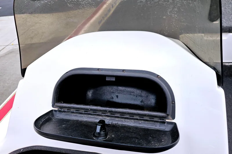 Slide: The Image of Open storage compartment on 1998 Champion 187 DLX Elite boat dashboard. - 26