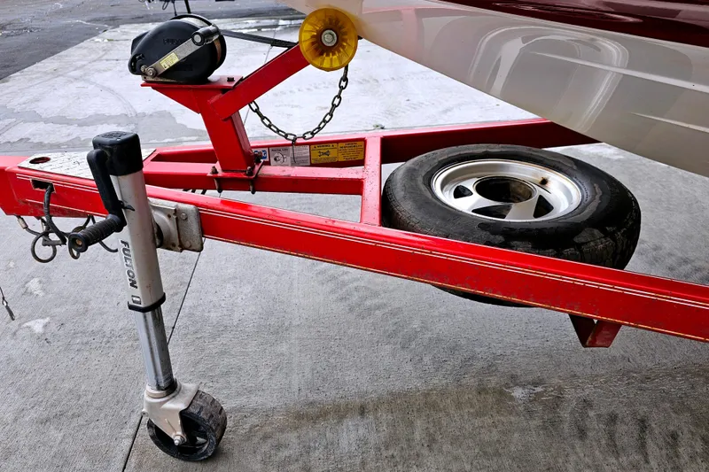 Slide: The Image of Red trailer with wheel and hitch for 1998 Champion 187 DLX Elite boat. - 27