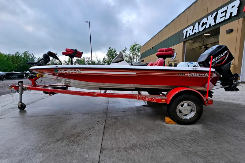 Slide: The Image of 1998 Champion 187 DLX Elite boat on trailer, parked outside Tracker building. - 4