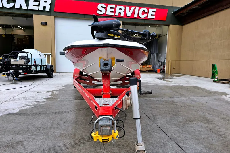 Slide: The Image of 1998 Champion 187 DLX Elite boat on red trailer at service center. - 6