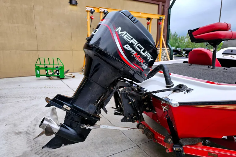 Slide: The Image of 1998 Champion 187 DLX Elite boat with Mercury Optimax engine, red and white design. - 8