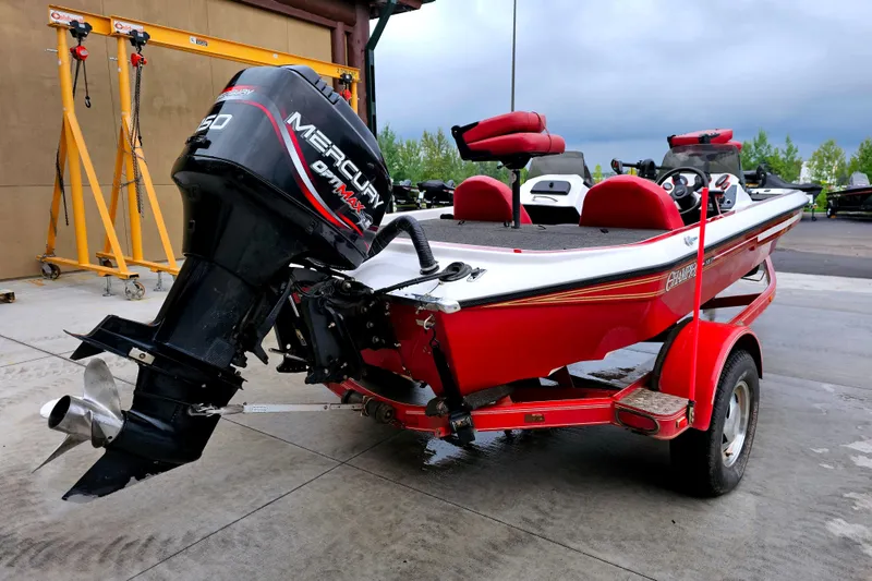 Slide: The Image of 1998 Champion 187 DLX Elite boat with Mercury outboard motor on a red trailer. - 9
