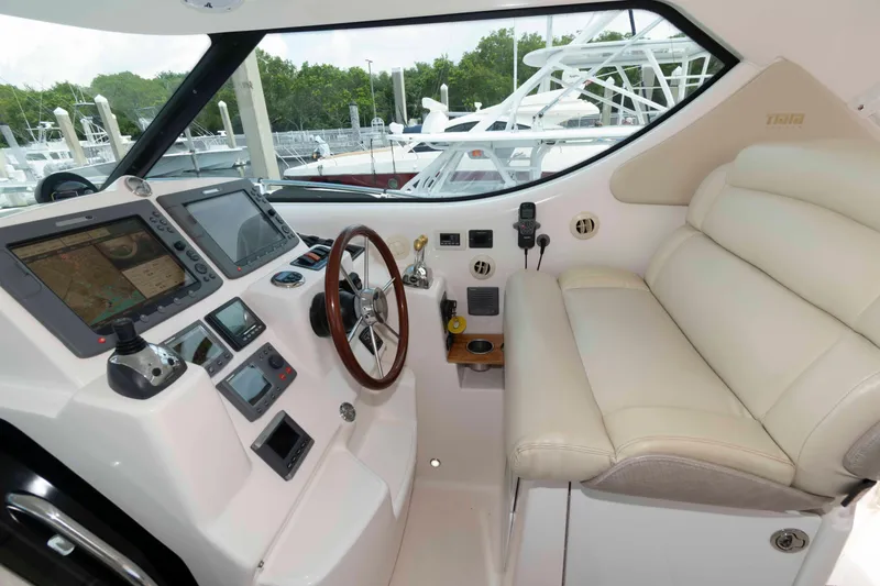 Slide: The Image of 2007 Tiara Yachts 4300 Sovran helm with leather seating and advanced navigation systems. - 12