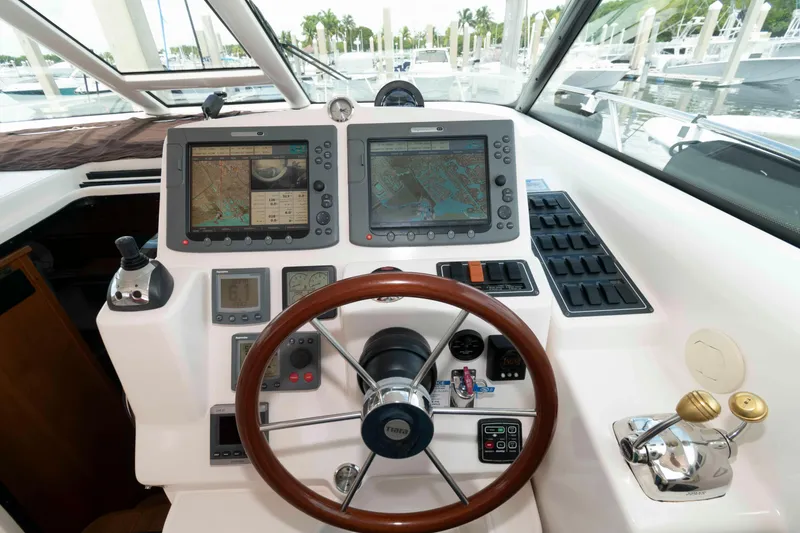 Slide: The Image of 2007 Tiara Yachts 4300 Sovran helm with navigation screens and controls. - 14