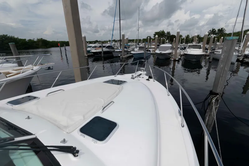 Slide: The Image of 2007 Tiara Yachts 4300 Sovran docked at marina, surrounded by other boats. - 16