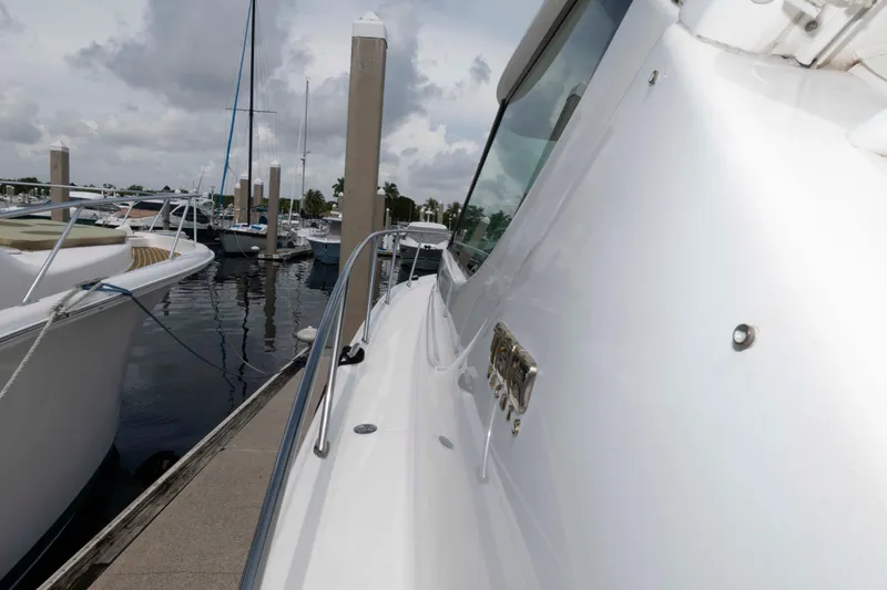 Slide: The Image of 2007 Tiara Yachts 4300 Sovran docked at marina, side view with cloudy sky. - 18