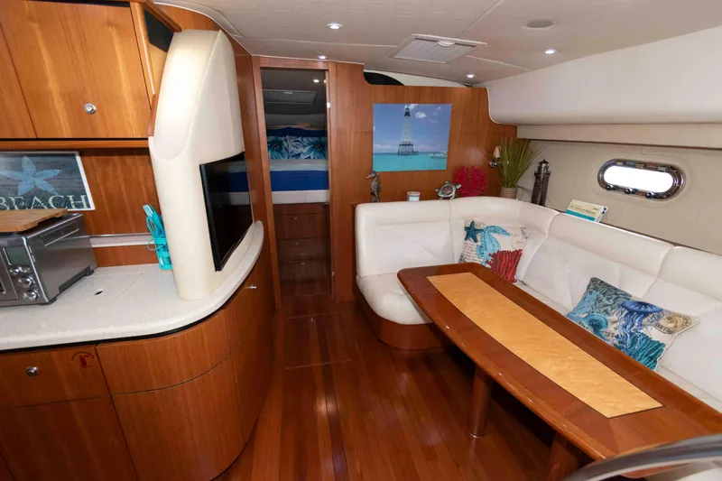 Slide: The Image of 2007 Tiara Yachts 4300 Sovran interior with wood finish and cozy seating area. - 19