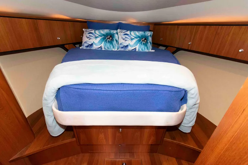Slide: The Image of Luxurious cabin interior of 2007 Tiara Yachts 4300 Sovran with blue bedding and wood finish. - 25