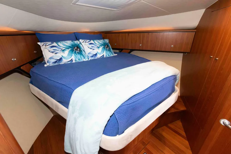 Slide: The Image of Luxurious cabin interior of 2007 Tiara Yachts 4300 Sovran with blue bedding and wood accents. - 26
