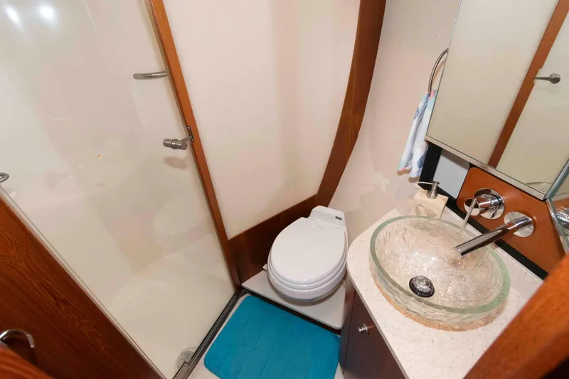 Slide: The Image of Luxurious 2007 Tiara Yachts 4300 Sovran bathroom with glass sink and modern fixtures. - 27