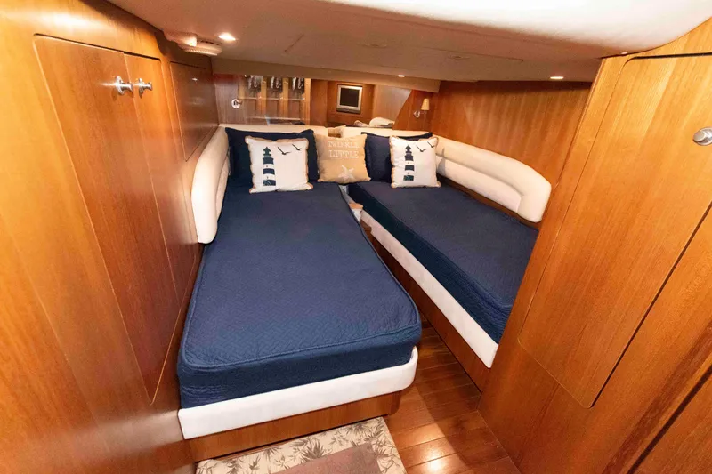 Slide: The Image of Luxurious 2007 Tiara Yachts 4300 Sovran cabin with twin beds and nautical decor. - 28