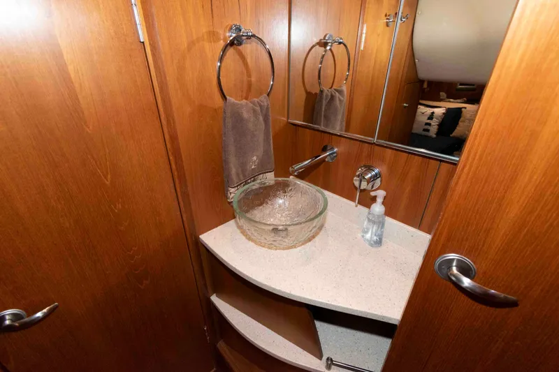Slide: The Image of Luxurious 2007 Tiara Yachts 4300 Sovran bathroom with glass sink and wooden cabinetry. - 29