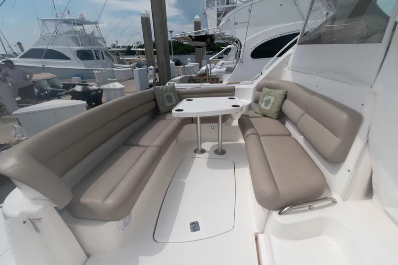 Slide: The Image of 2007 Tiara Yachts 4300 Sovran cockpit with beige seating and table, docked at marina. - 5