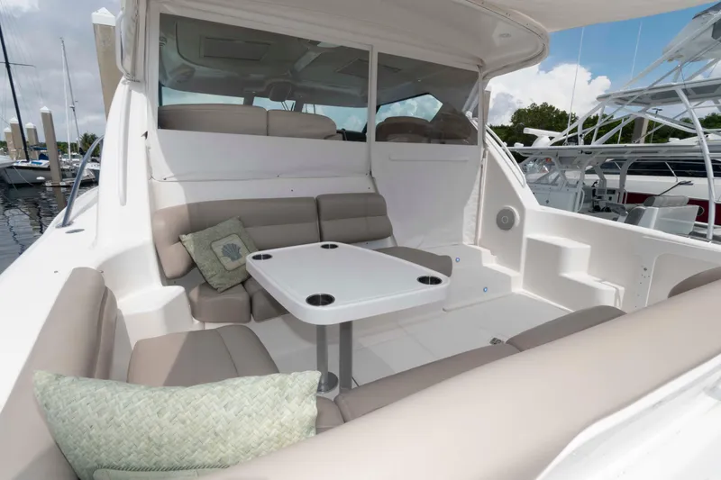 Slide: The Image of 2007 Tiara Yachts 4300 Sovran interior with seating and table, docked at marina. - 6