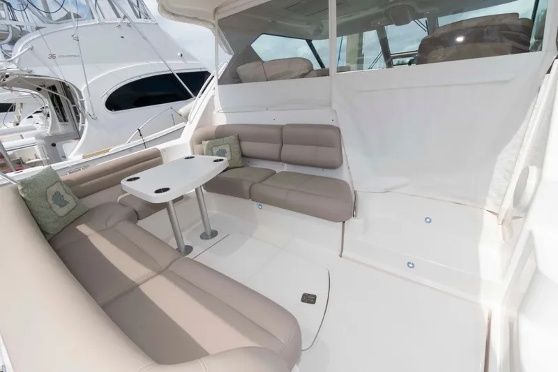 Slide: The Image of 2007 Tiara Yachts 4300 Sovran interior with cushioned seating and table. - 7
