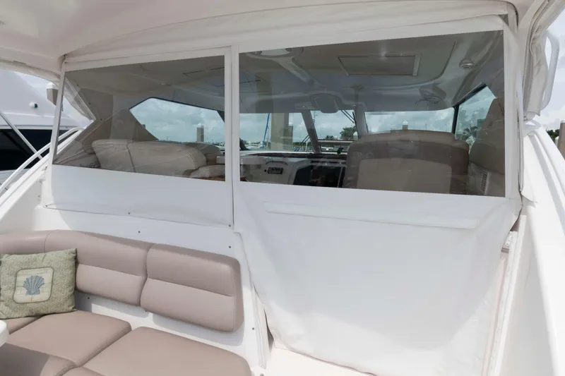 Slide: The Image of 2007 Tiara Yachts 4300 Sovran interior with cushioned seating and clear enclosure. - 9