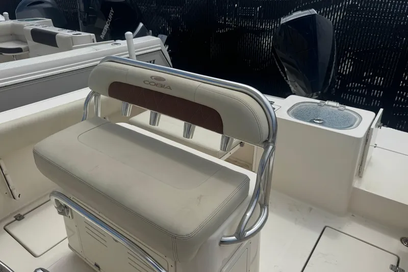 Slide: The Image of 2022 Cobia 237 Center Console boat interior with seating and rod holders. - 10