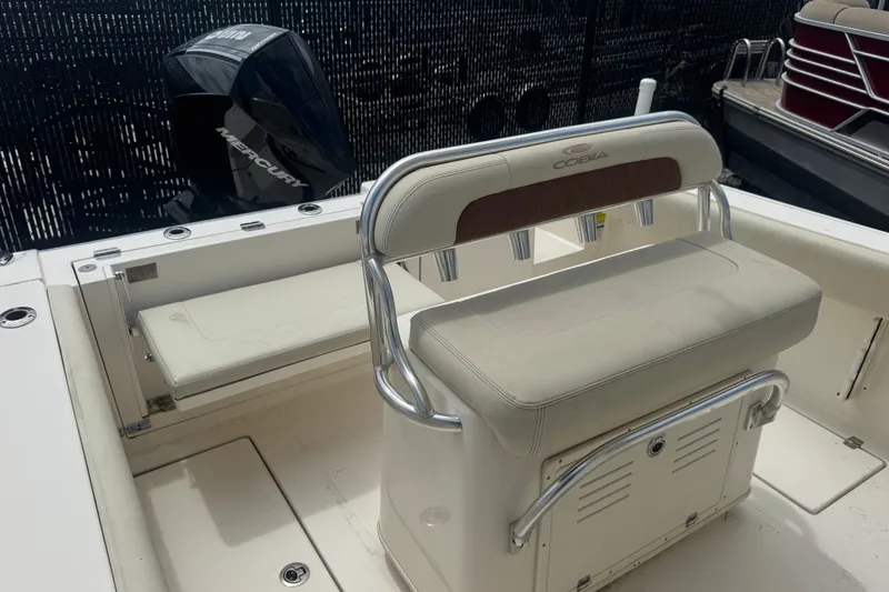 Slide: The Image of 2022 Cobia 237 Center Console boat interior with seating and Mercury engine. - 11