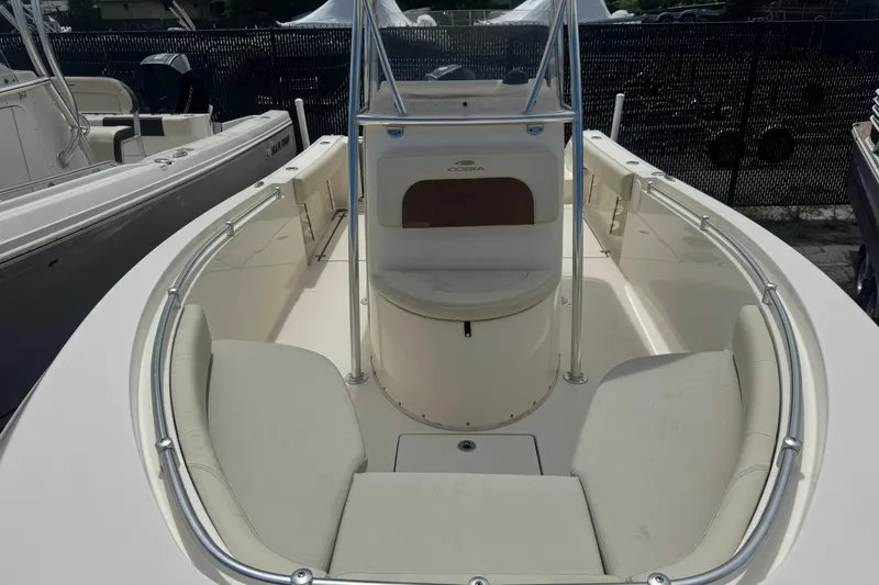 Slide: The Image of 2022 Cobia 237 Center Console boat interior with cushioned seating and sleek design. - 4