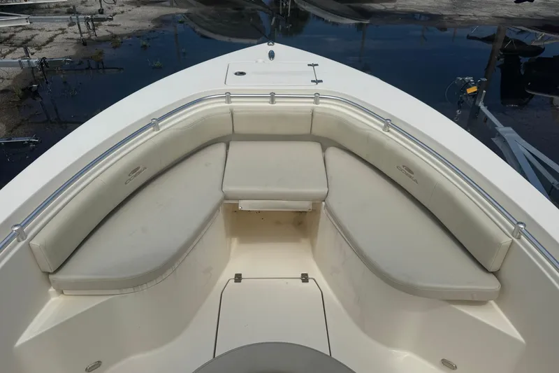 Slide: The Image of 2022 Cobia 237 Center Console boat with cushioned seating area. - 5