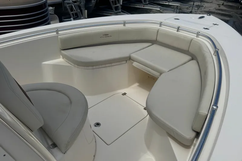 Slide: The Image of 2022 Cobia 237 Center Console boat with cushioned seating area. - 6