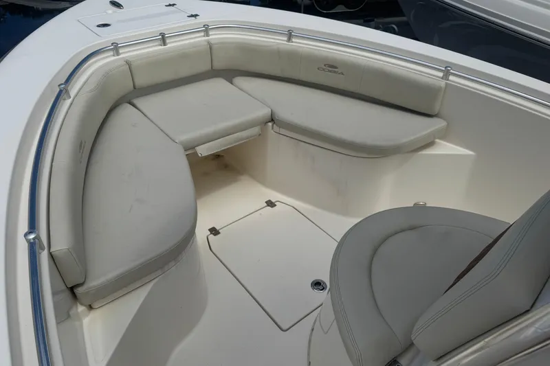 Slide: The Image of 2022 Cobia 237 Center Console boat with cushioned seating area. - 7