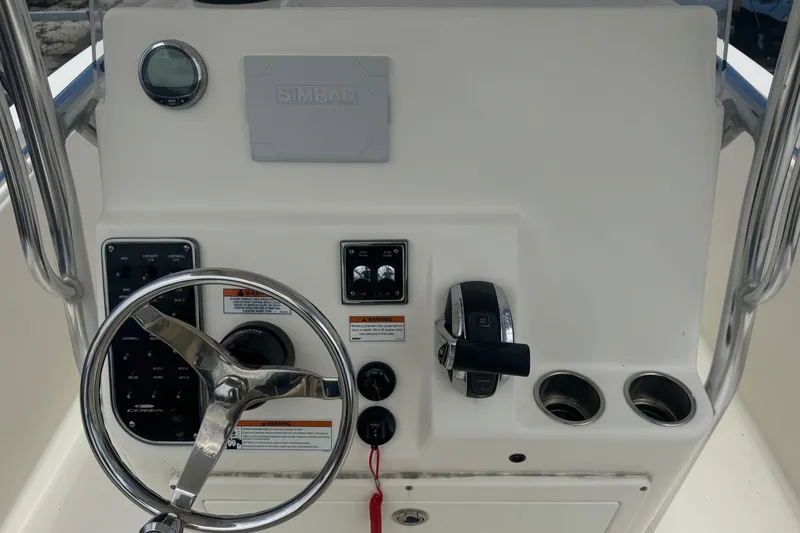 Slide: The Image of 2022 Cobia 237 Center Console dashboard with steering wheel and controls. - 8