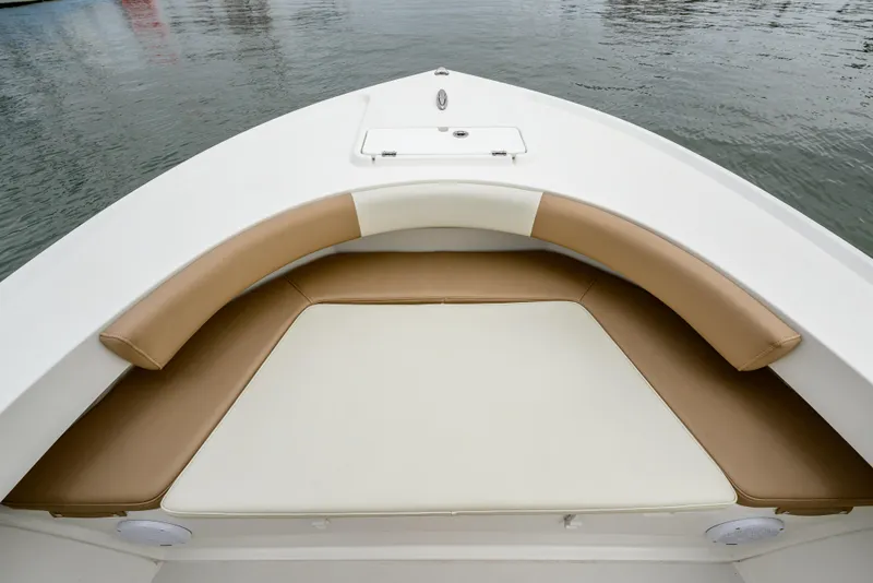 Slide: The Image of Bow seating area of 2018 Parker 21 Special Edition boat with tan cushions. - 16