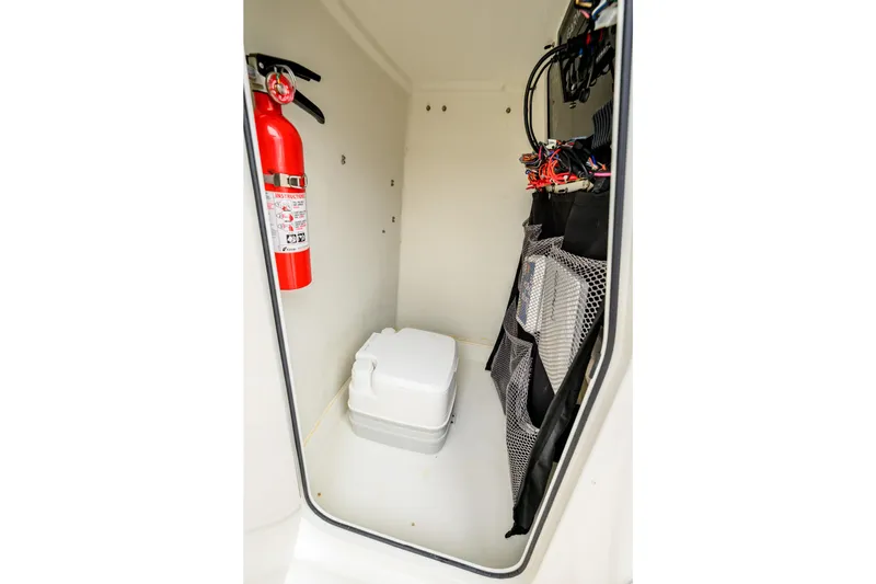 Slide: The Image of Compact storage area in Parker 21 Special Edition 2018, featuring fire extinguisher and portable toilet. - 17